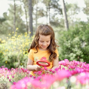 Girl Examining Flowers